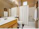 Clean bathroom featuring a shower-tub combo, large mirror, and a light wood vanity at 9525 Salem Hills Ct, Las Vegas, NV 89134