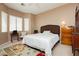Cozy bedroom with neutral decor, a comfortable bed, and natural light from the windows at 9525 Salem Hills Ct, Las Vegas, NV 89134