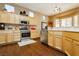 Modern kitchen with stainless steel appliances, light wood cabinets, and ample counter space at 9525 Salem Hills Ct, Las Vegas, NV 89134