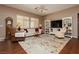 Inviting living room with neutral walls, ceiling fan, and wood laminate flooring at 9525 Salem Hills Ct, Las Vegas, NV 89134