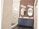 This bathroom features a large double vanity, modern lighting, and a walk-in shower at 9604 Flying Eagle Ln, Las Vegas, NV 89123