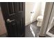 Bathroom with black marble floors leading to a modern toilet and glass enclosed shower at 9604 Flying Eagle Ln, Las Vegas, NV 89123