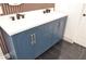 Bathroom with double sinks, sleek matte black faucets, and blue vanity at 9604 Flying Eagle Ln, Las Vegas, NV 89123