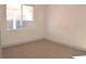 An ample bedroom features neutral carpet and a window, creating a bright, inviting space at 9604 Flying Eagle Ln, Las Vegas, NV 89123