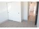 Neutral bedroom featuring carpet and a wardrobe or closet with adjacent view of open doorway and hardwood floors at 9604 Flying Eagle Ln, Las Vegas, NV 89123