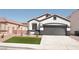 Charming single-story home featuring a manicured lawn and a two-car garage at 9604 Flying Eagle Ln, Las Vegas, NV 89123