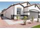 Charming single story home with a gray garage door, red rock landscaping, and sidewalk at 9604 Flying Eagle Ln, Las Vegas, NV 89123