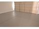 An open, clean garage with painted concrete floors and a standard paneled door at 9604 Flying Eagle Ln, Las Vegas, NV 89123
