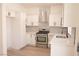 Modern white kitchen featuring stainless steel appliances and quartz countertops at 9604 Flying Eagle Ln, Las Vegas, NV 89123