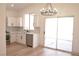 Bright kitchen with white cabinets, stainless steel appliances, and sliding glass doors to patio at 9604 Flying Eagle Ln, Las Vegas, NV 89123