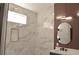 This bathroom features an ample walk-in shower with a stylish shower head and marble tiling at 9604 Flying Eagle Ln, Las Vegas, NV 89123