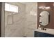 A stylish walk-in shower with marble tiling, built-in niche, and modern fixtures at 9604 Flying Eagle Ln, Las Vegas, NV 89123