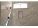 A well-lit marble walk-in shower showcasing modern fixtures and a built-in niche at 9604 Flying Eagle Ln, Las Vegas, NV 89123