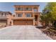 Two-story home featuring a spacious three car garage and a cozy second-story balcony at 9728 Panther Hollow St, Las Vegas, NV 89141