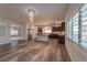 An open-concept kitchen featuring wood floors, a chandelier, and a breakfast bar at 9728 Panther Hollow St, Las Vegas, NV 89141