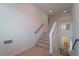 An open staircase featuring carpeted steps with contrasting white and dark rails to other levels at 9728 Panther Hollow St, Las Vegas, NV 89141