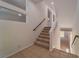 An open staircase featuring carpeted steps and tile landing with views to other levels at 9728 Panther Hollow St, Las Vegas, NV 89141