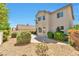 An inviting backyard showcasing a patio, complemented by stone landscaping and healthy shrubbery at 9748 Derbyhill Cir, Las Vegas, NV 89117