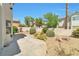 A backyard oasis featuring a concrete patio, stone landscaping, mature trees and greenery at 9748 Derbyhill Cir, Las Vegas, NV 89117