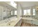 Bright bathroom features dual sinks and a separate tub at 9748 Derbyhill Cir, Las Vegas, NV 89117