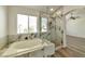 Modern bathroom with glass shower, large tub, and ample natural light at 9748 Derbyhill Cir, Las Vegas, NV 89117