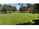 Scenic view of Ascot Community Park with lush green grass and mature trees at 9748 Derbyhill Cir, Las Vegas, NV 89117