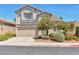 Charming two-story home featuring a tan stucco exterior, complemented by a well-manicured front yard at 9748 Derbyhill Cir, Las Vegas, NV 89117