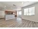 Open-concept kitchen and living area featuring wood-look floors and ample natural light at 9748 Derbyhill Cir, Las Vegas, NV 89117