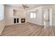 Inviting living room with wood-look floors, featuring a tiled fireplace and open layout at 9748 Derbyhill Cir, Las Vegas, NV 89117
