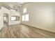 Expansive living room with vaulted ceiling, wood-look floors, and a view to the second story at 9748 Derbyhill Cir, Las Vegas, NV 89117