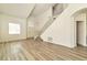 Spacious living room features vaulted ceilings, wood-look flooring, and an open staircase to the second story at 9748 Derbyhill Cir, Las Vegas, NV 89117