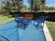 Outdoor seating with table and chairs offers a relaxing space with colorful seating and table at 9748 Derbyhill Cir, Las Vegas, NV 89117