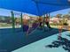 Vibrant community playground with climbing structures, slides, and a shaded area for fun at 9748 Derbyhill Cir, Las Vegas, NV 89117