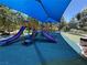 Community playground with slides and soft padded ground, perfect for recreational fun and safety at 9748 Derbyhill Cir, Las Vegas, NV 89117
