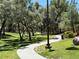 Picturesque walking path winds through a shady green space, offering a peaceful and scenic outdoor experience at 9748 Derbyhill Cir, Las Vegas, NV 89117