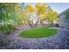 Large backyard with a lush lawn, patio and mature trees providing plenty of shade and privacy at 10391 Avebury Manor Ln, Las Vegas, NV 89135