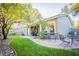 Backyard featuring a paved patio with seating, a lush green lawn and mature trees for shade and privacy at 10391 Avebury Manor Ln, Las Vegas, NV 89135