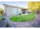A lush backyard with green grass, trees, and a paved patio, perfect for outdoor enjoyment at 10391 Avebury Manor Ln, Las Vegas, NV 89135