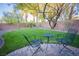 Well manicured backyard offers an outdoor seating area and green grass at 10391 Avebury Manor Ln, Las Vegas, NV 89135