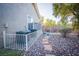 The backyard features river rock ground cover, A/C unit, and a fenced in area with two bikes at 10391 Avebury Manor Ln, Las Vegas, NV 89135