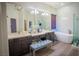 Luxurious bathroom with double sinks, soaking tub, and glass-enclosed shower at 10391 Avebury Manor Ln, Las Vegas, NV 89135