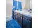 Bathroom featuring double sink vanity, tub and shower with blue curtain and decor at 10391 Avebury Manor Ln, Las Vegas, NV 89135