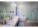 Elegant bathroom featuring double sinks, soaking tub, and glass shower at 10391 Avebury Manor Ln, Las Vegas, NV 89135