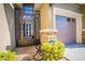 Gated entrance leading to a garage and front door at 10391 Avebury Manor Ln, Las Vegas, NV 89135