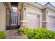 Gated entrance leading to a garage and front door at 10391 Avebury Manor Ln, Las Vegas, NV 89135
