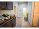 Hallway with access to doors, cabinets, and hall seating at 10391 Avebury Manor Ln, Las Vegas, NV 89135