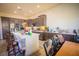 Bright kitchen with a white center island, dark wood cabinets, and stainless steel appliances at 10391 Avebury Manor Ln, Las Vegas, NV 89135