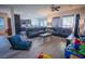 Expansive open-concept living area featuring hardwood floors, lots of natural light, and modern furnishings at 10391 Avebury Manor Ln, Las Vegas, NV 89135