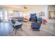 Spacious living room with hardwood floors, ceiling fan, a comfy couch, and large windows at 10391 Avebury Manor Ln, Las Vegas, NV 89135