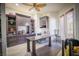 Home office with hardwood floors, custom shelving, and a ceiling fan at 10391 Avebury Manor Ln, Las Vegas, NV 89135